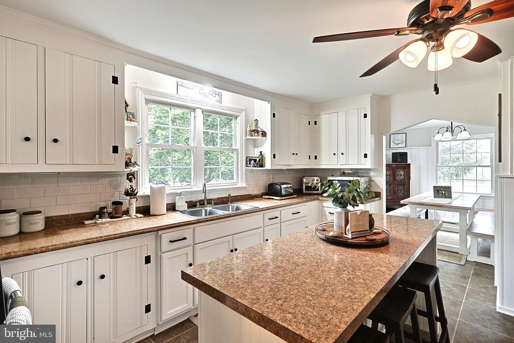 6927 York Road Abbottstown, PA 17301 - Photo 20 of 41 a kitchen with a table chairs and white cabinets