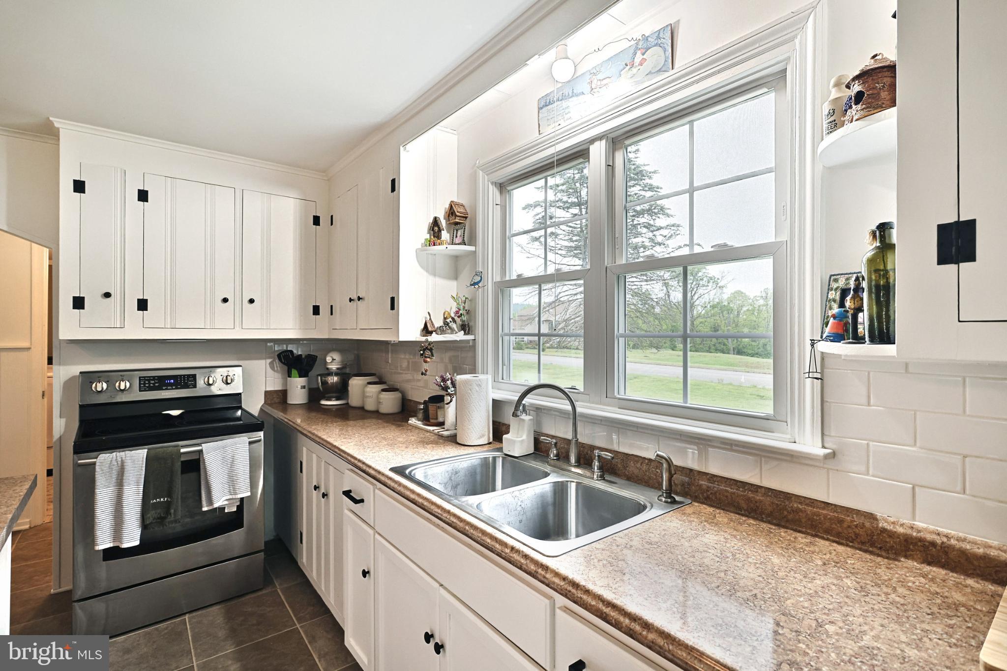 6927 York Road Abbottstown, PA 17301 - Photo 21 of 41 a kitchen with granite countertop a sink a counter top space and stainless steel appliances