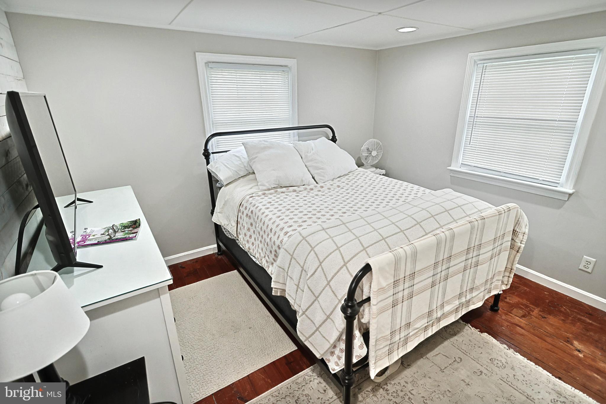 6927 York Road Abbottstown, PA 17301 - Photo 27 of 41 a bedroom with a bed and wooden floor