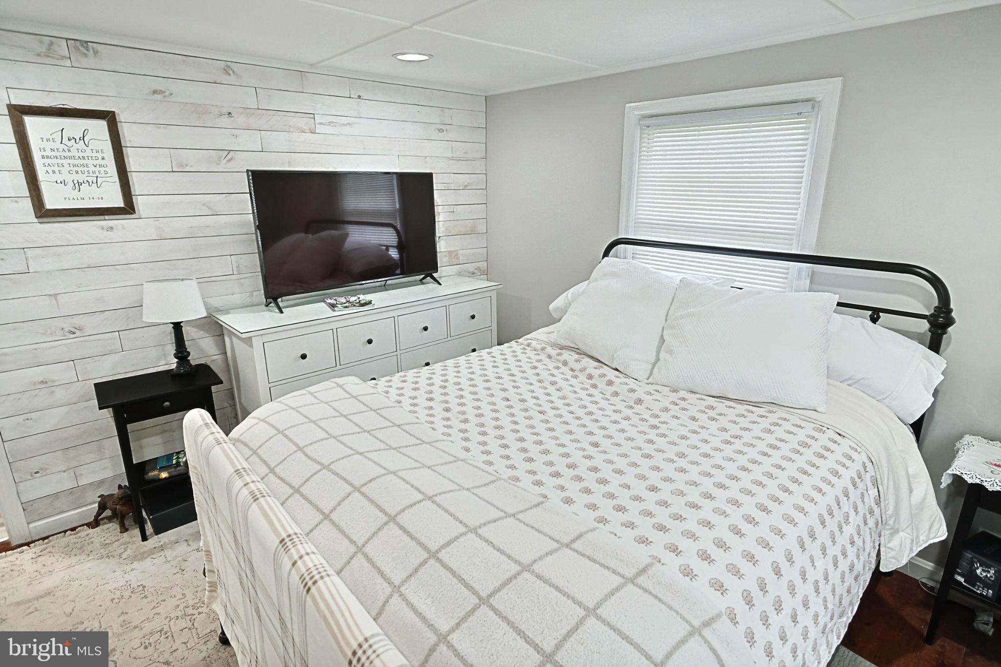 6927 York Road Abbottstown, PA 17301 - Photo 28 of 41 a bedroom with a bed and a flat screen tv