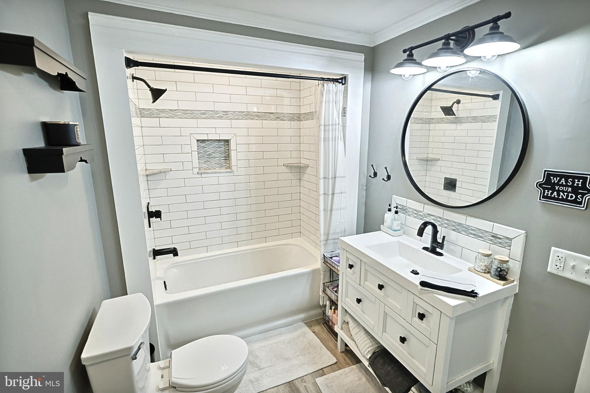 6927 York Road Abbottstown, PA 17301 - Photo 29 of 41 a bathroom with a sink mirror toilet and bathtub