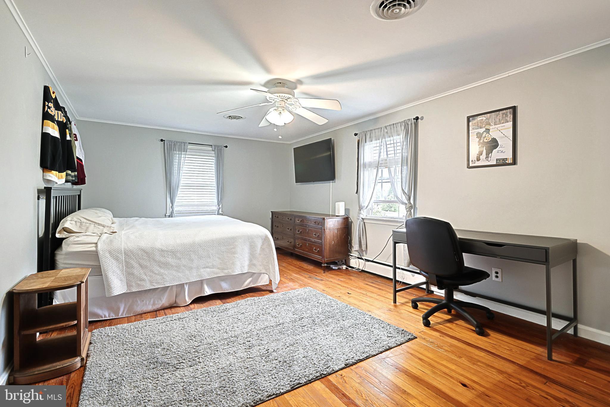 6927 York Road Abbottstown, PA 17301 - Photo 37 of 41 a bedroom with a bed a chair and a chandelier