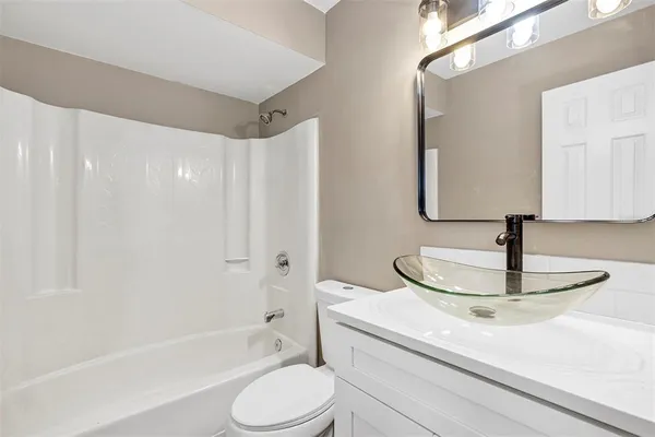 a bathroom with a sink a toilet and a bathtub