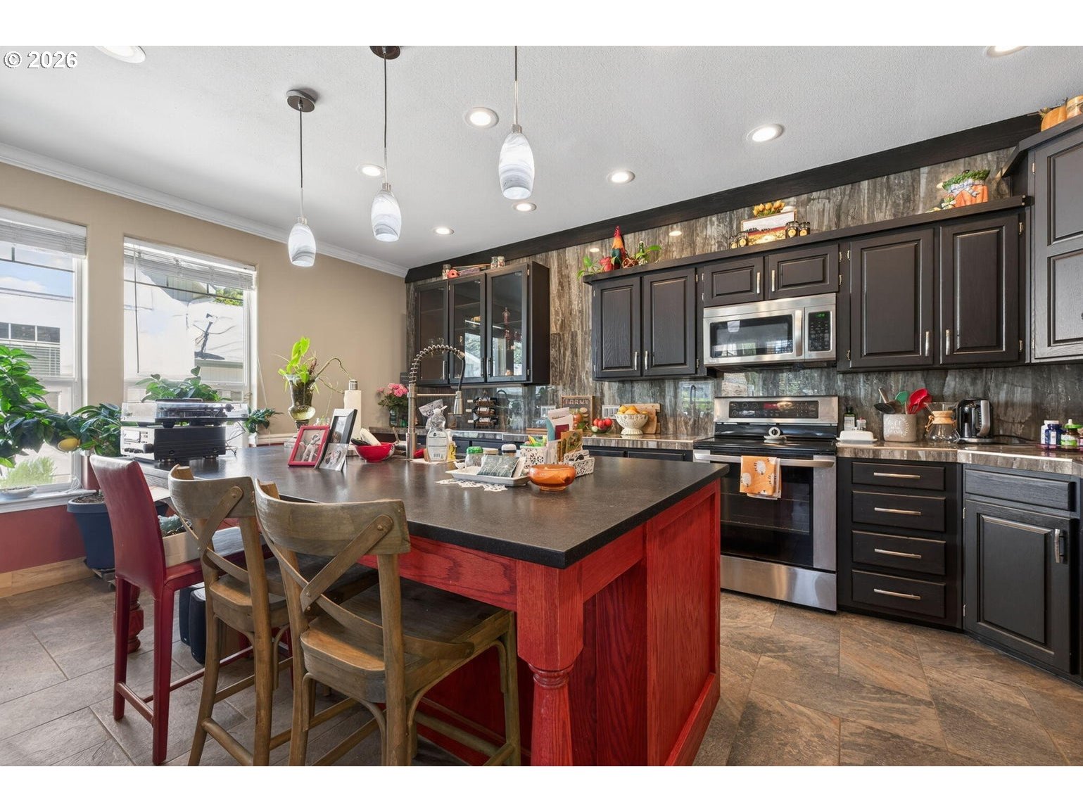 538 North Tam Rim Drive Sisters, OR 97759 - Photo 13 of 45 a kitchen with stainless steel appliances kitchen island granite countertop a table chairs and a refrigerator