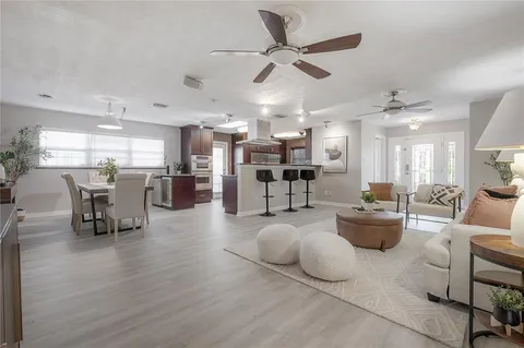 a living room with furniture and kitchen view