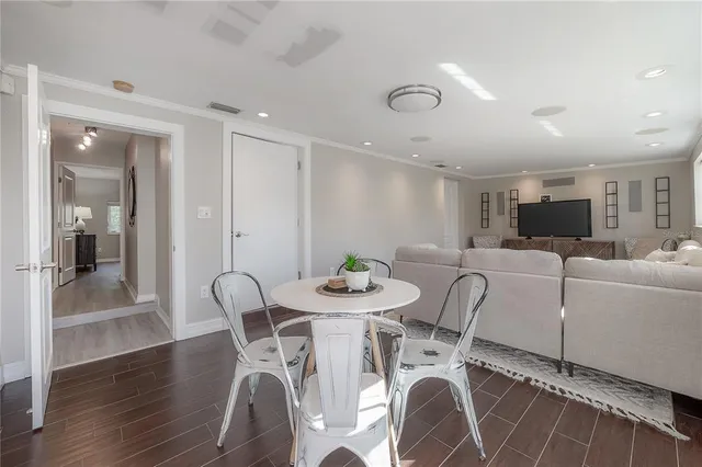 a view of a dining room with furniture and wooden floor