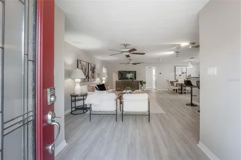 a living room with furniture and a wooden floor