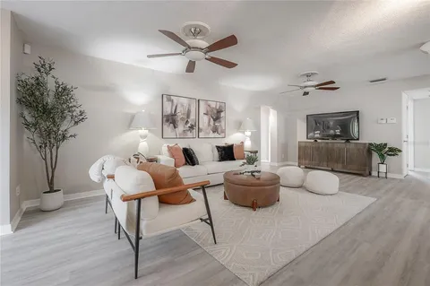 a living room with furniture and a chandelier