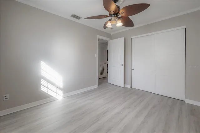 a bathroom with a granite countertop toilet sink and mirror