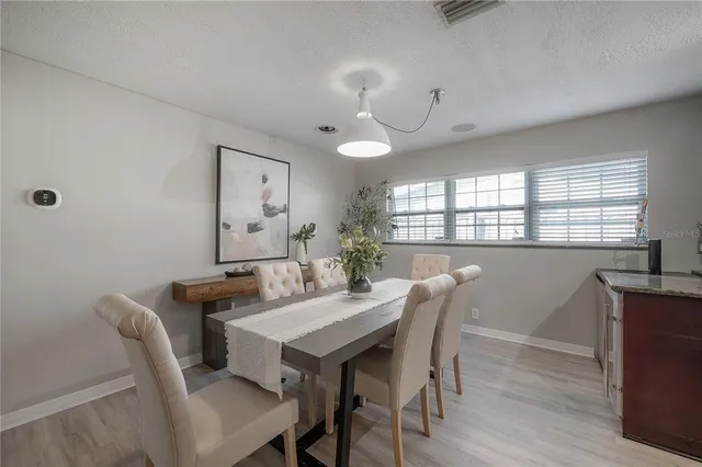a view of a dining room with furniture and window