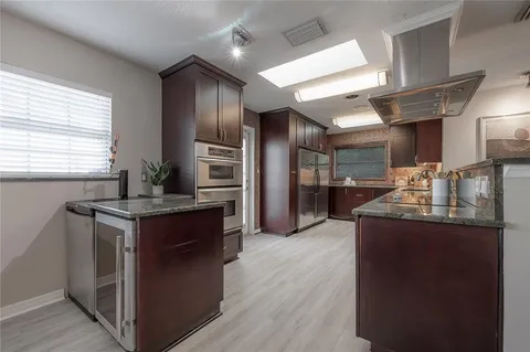a kitchen with stainless steel appliances granite countertop a stove and a refrigerator
