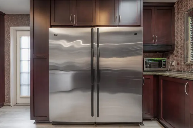 a kitchen with a refrigerator and a sink