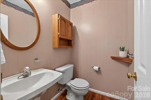a bathroom with a sink a toilet and a mirror