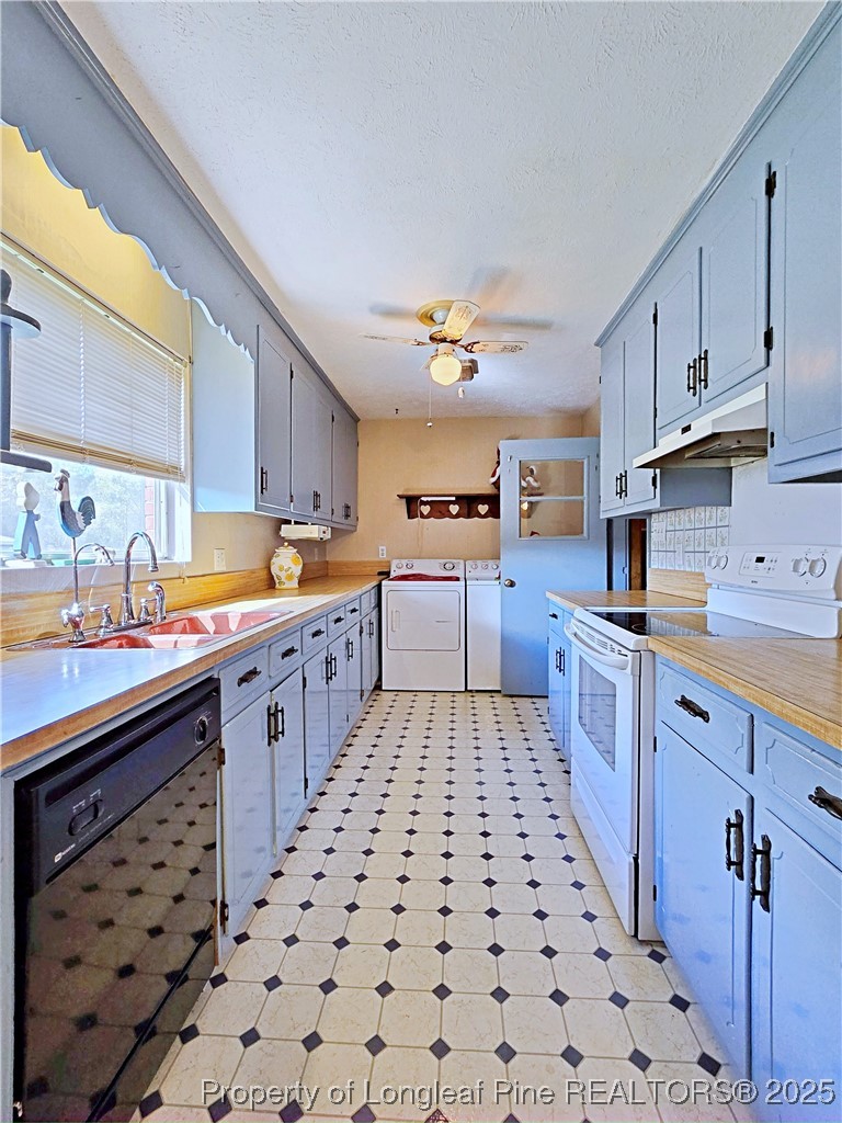 764 Old Vander Road Fayetteville, NC 28312 - Photo 9 of 50 a kitchen with stainless steel appliances a sink a stove a refrigerator and cabinets