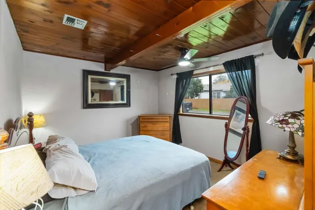 a bedroom with bed and wooden floor