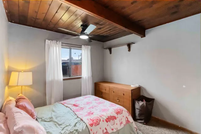 a bedroom with a bed and a dresser