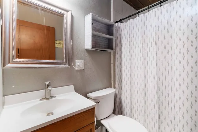 a white toilet sitting next to a bathroom sink
