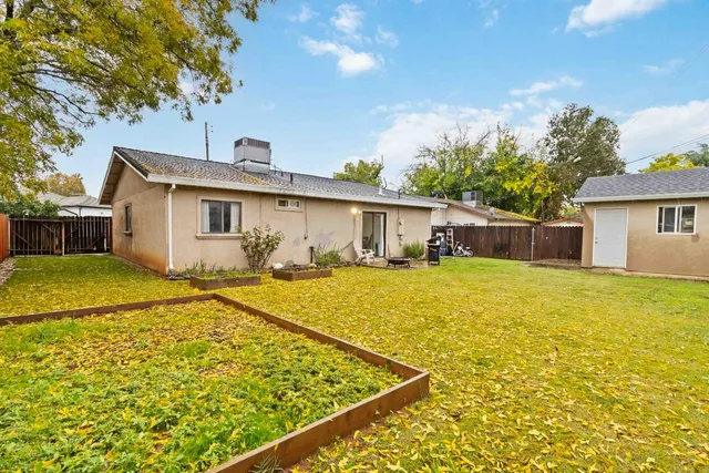 a front view of house with yard outdoor seating and barbeque oven