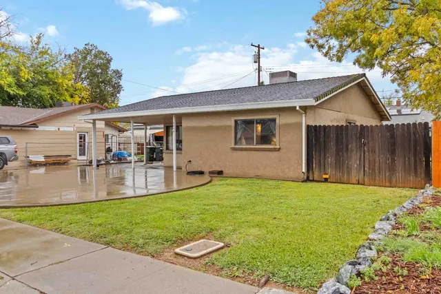 a view of a house with a yard patio and swimming pool