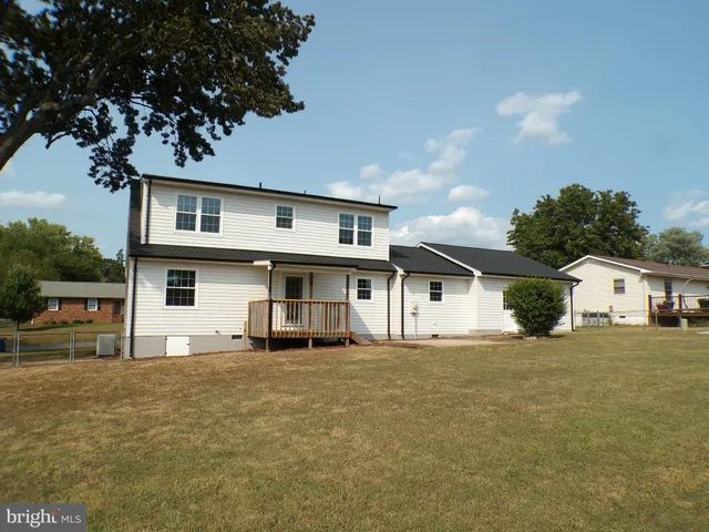a view of a white house with a yard
