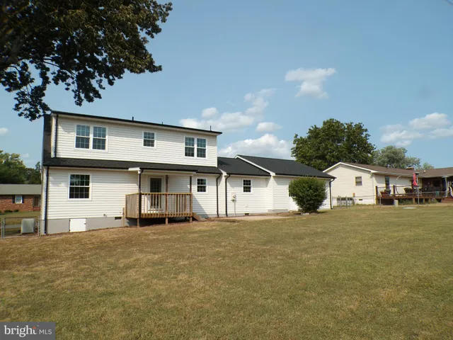 a house that has a big tree in front of it