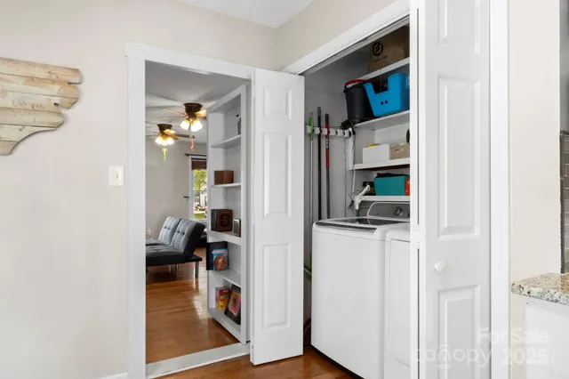 a view of living room with furniture and wooden floor