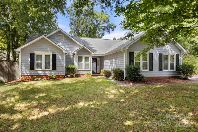 a front view of a house with yard and green space