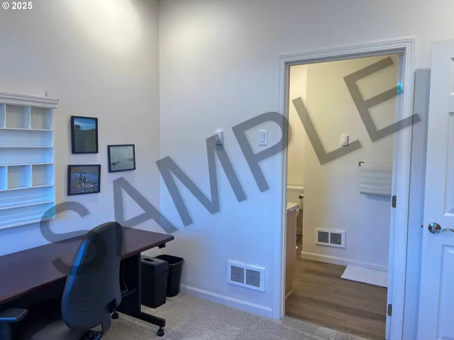 a bathroom with a granite countertop sink and a toilet
