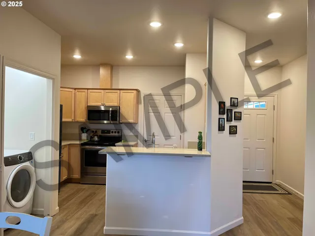 a kitchen with stainless steel appliances granite countertop a refrigerator stove and microwave