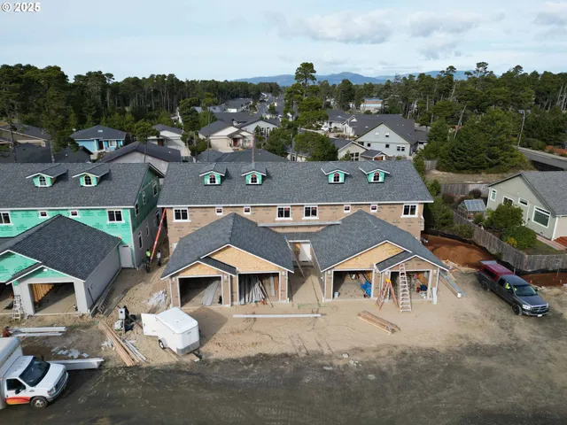 an aerial view of residential houses with outdoor space and street view