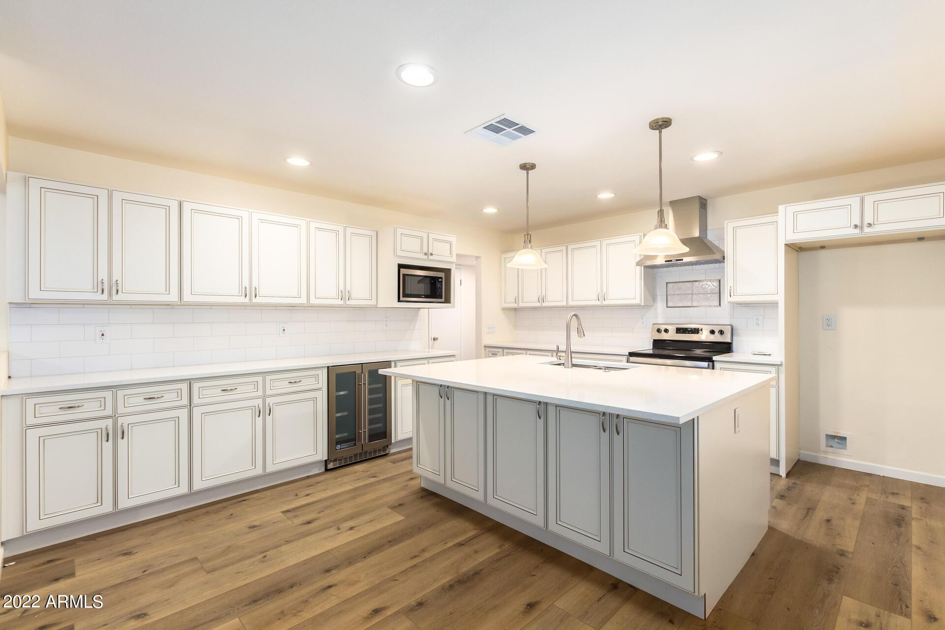 1211 West Hayward Avenue Phoenix, AZ 85021 - Photo 11 of 26 a kitchen with a sink cabinets and wooden floor