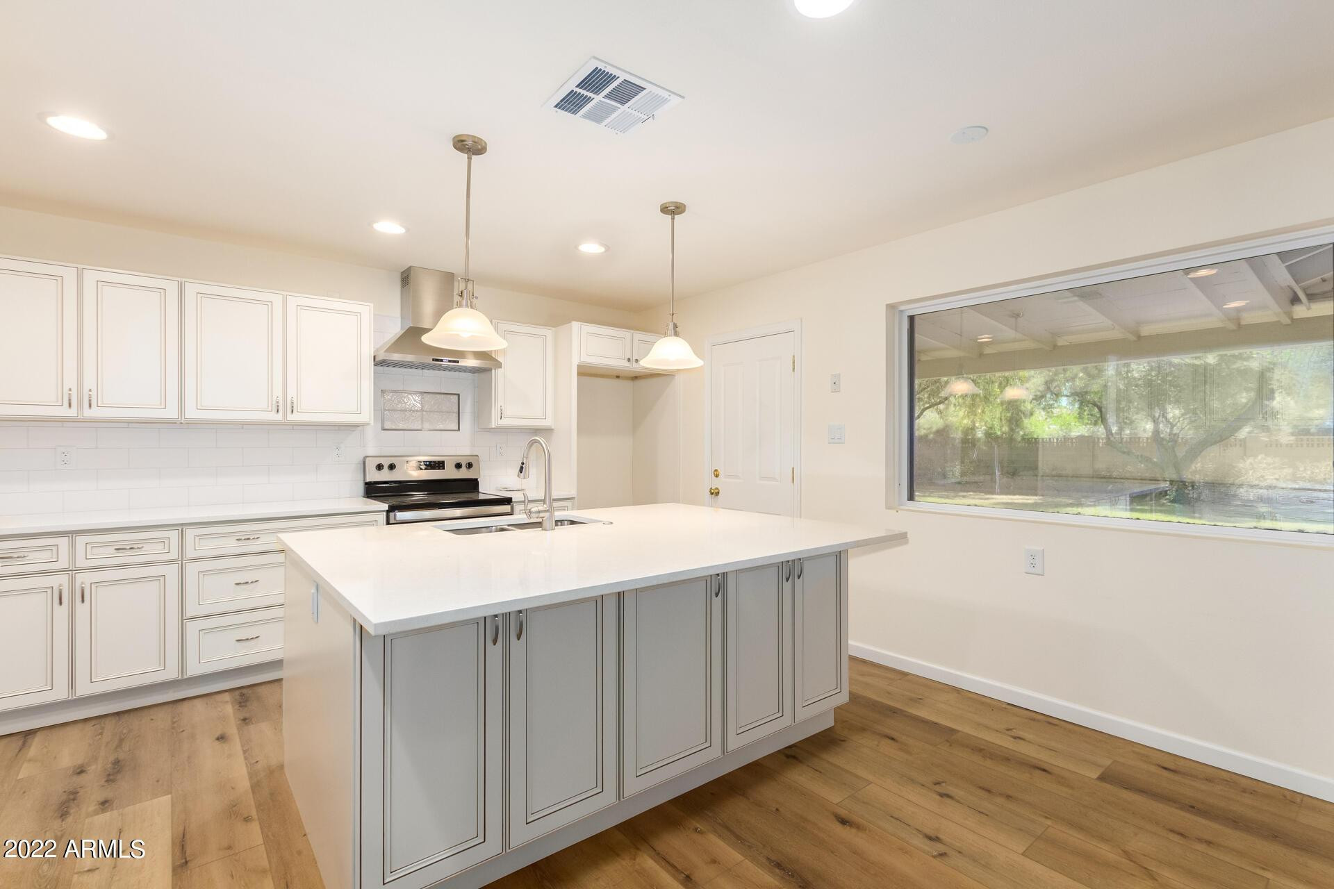 1211 West Hayward Avenue Phoenix, AZ 85021 - Photo 12 of 26 a kitchen with a sink a stove a refrigerator and window