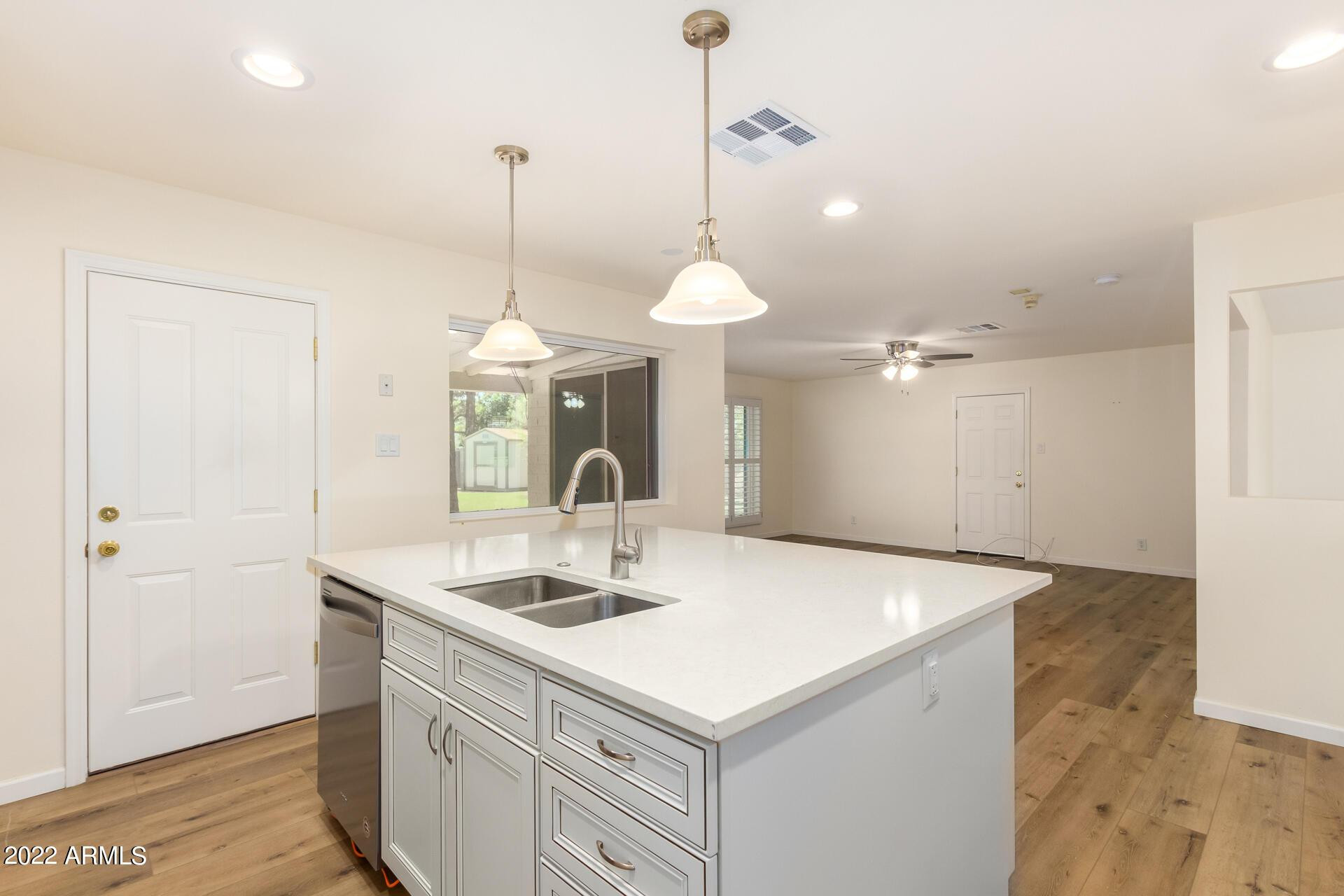 1211 West Hayward Avenue Phoenix, AZ 85021 - Photo 14 of 26 a kitchen with a sink cabinets and wooden floor