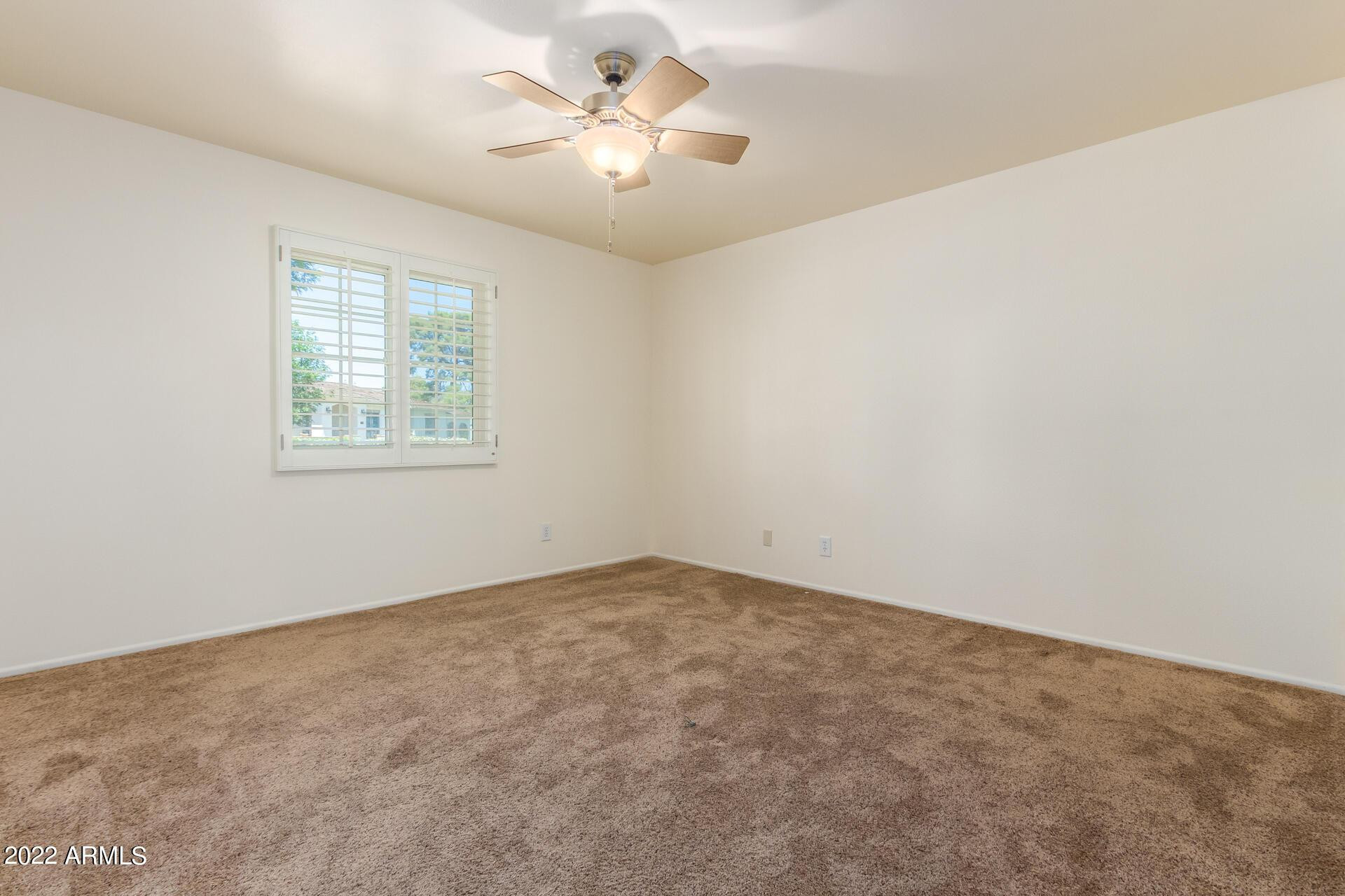 1211 West Hayward Avenue Phoenix, AZ 85021 - Photo 15 of 26 an empty room with windows and fan