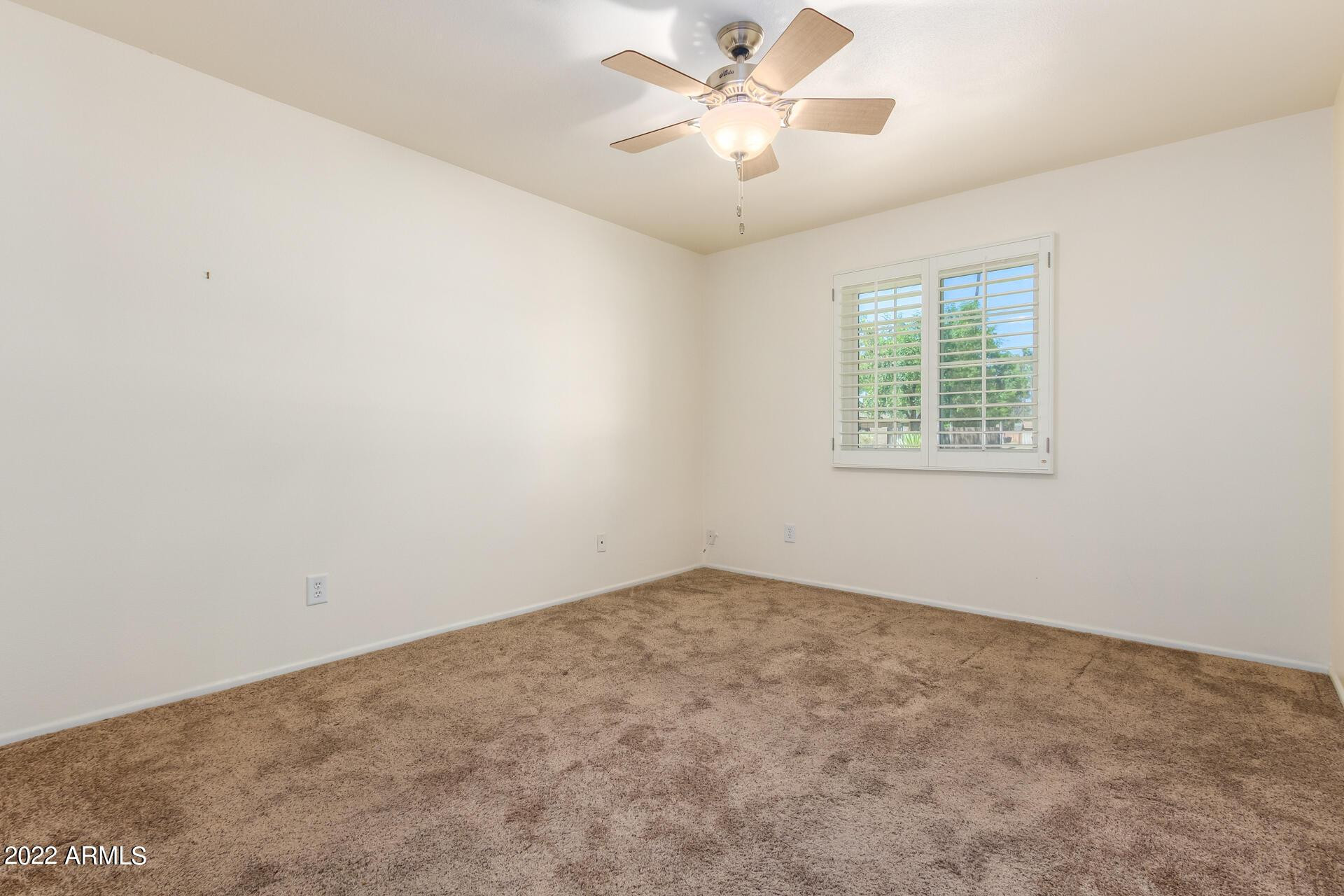 1211 West Hayward Avenue Phoenix, AZ 85021 - Photo 17 of 26 an empty room with a window and a fan