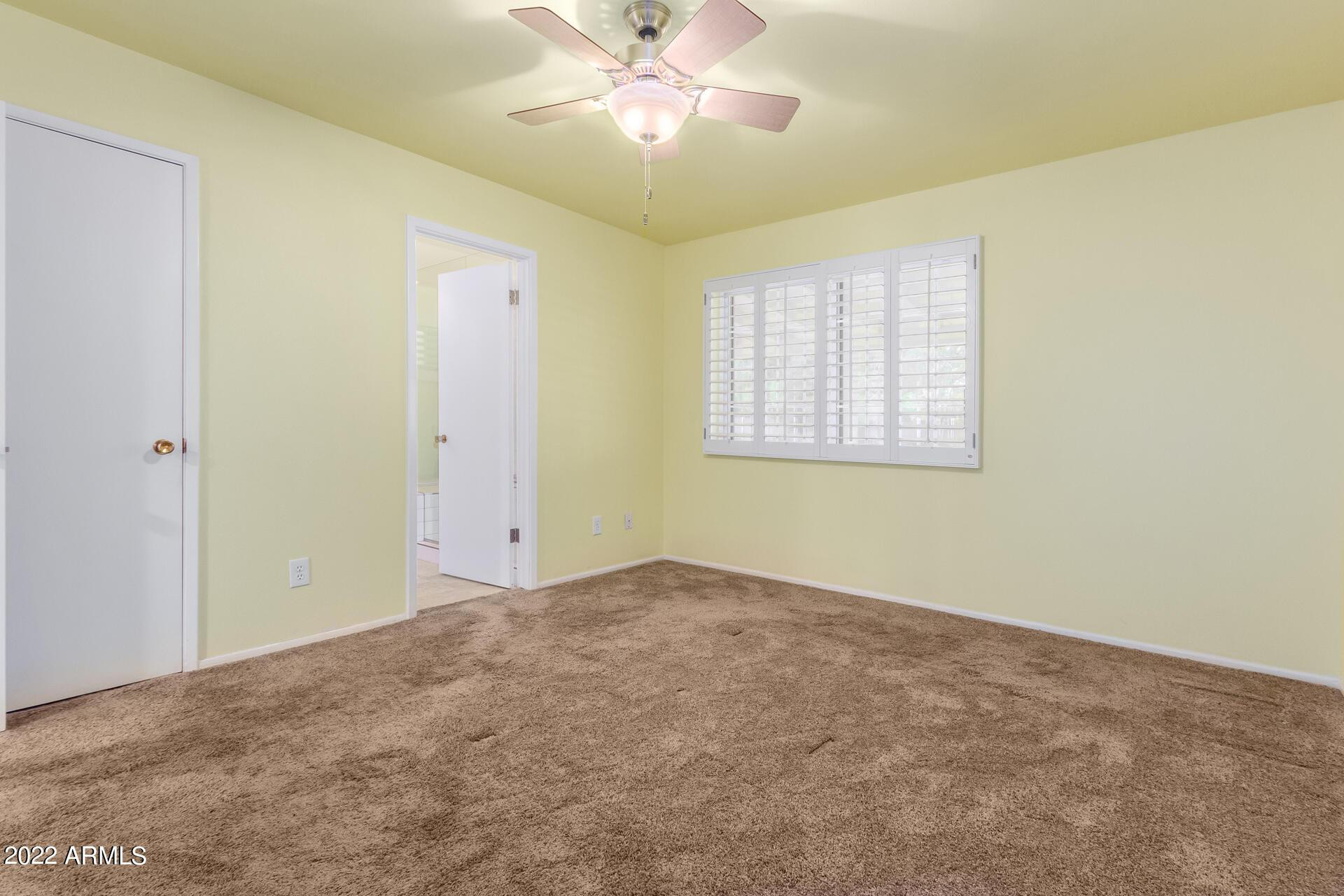 1211 West Hayward Avenue Phoenix, AZ 85021 - Photo 20 of 26 an empty room with windows and fan