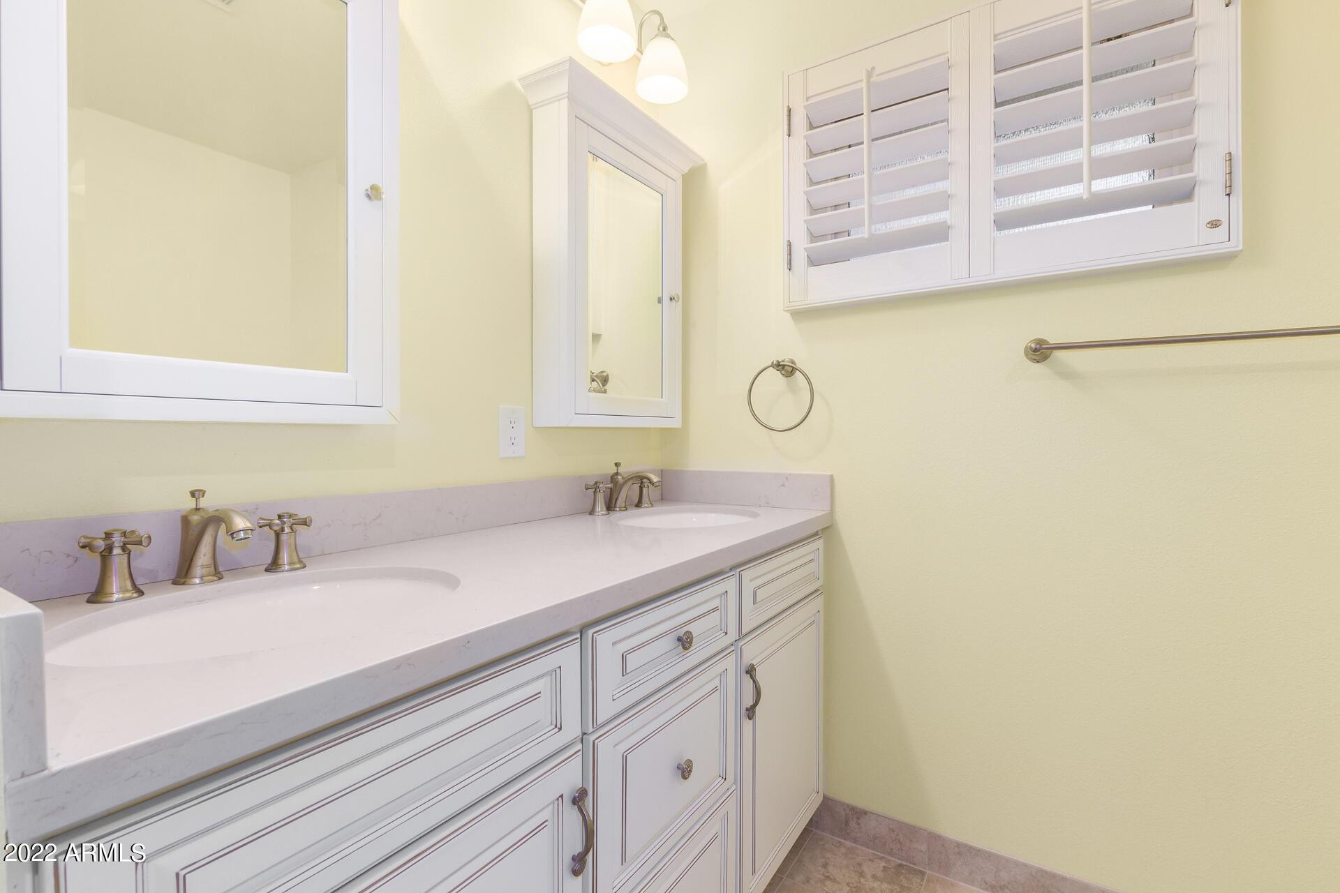 1211 West Hayward Avenue Phoenix, AZ 85021 - Photo 23 of 26 a bathroom with a sink and a mirror