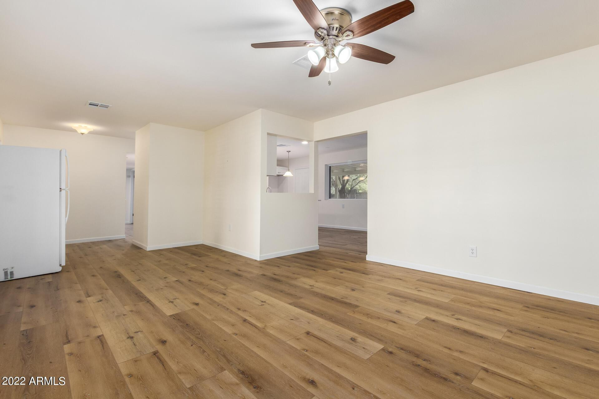 1211 West Hayward Avenue Phoenix, AZ 85021 - Photo 4 of 26 a view of empty room with wooden floor