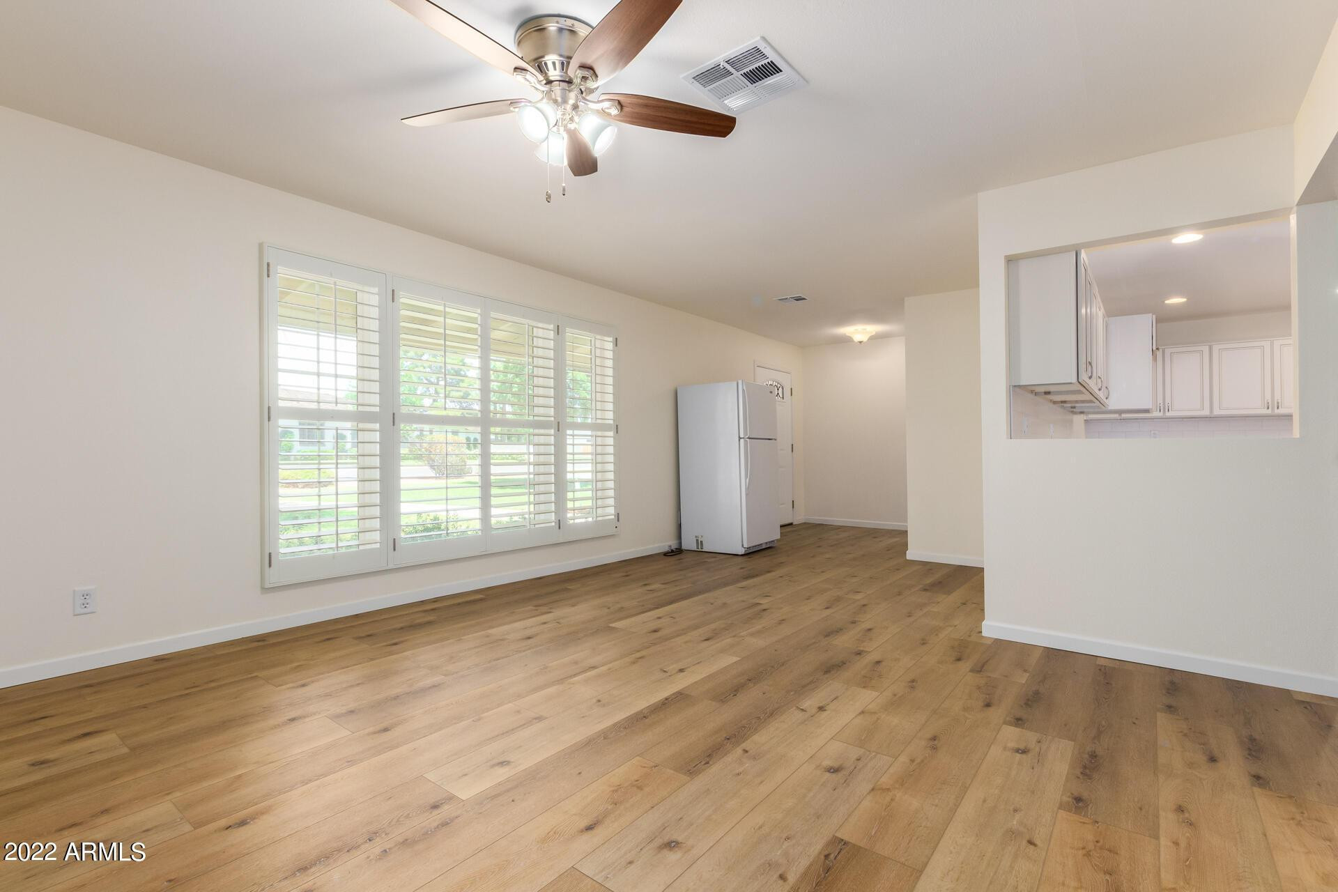 1211 West Hayward Avenue Phoenix, AZ 85021 - Photo 6 of 26 a view of empty room with wooden floor and fan