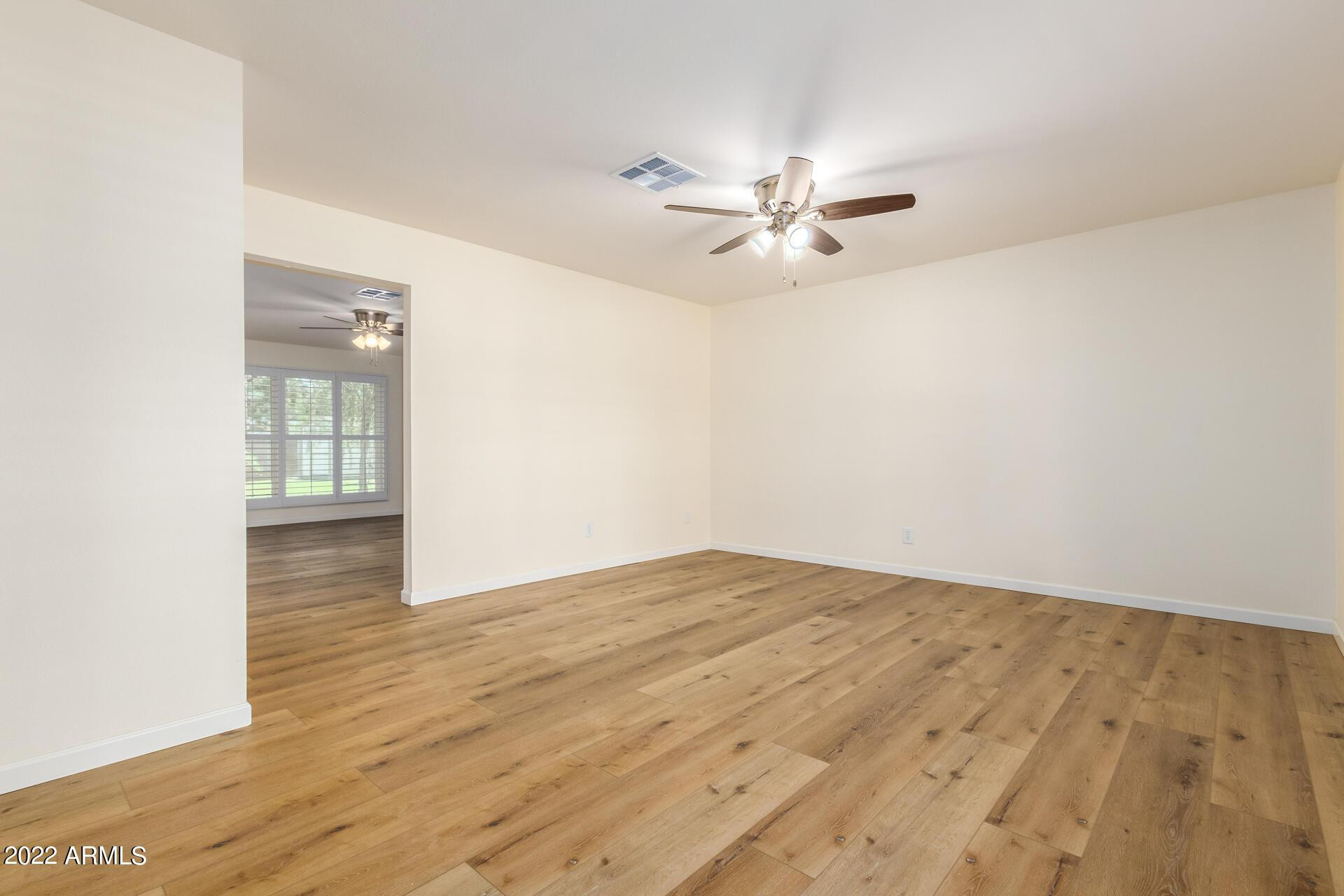 1211 West Hayward Avenue Phoenix, AZ 85021 - Photo 7 of 26 a view of empty room with wooden floor