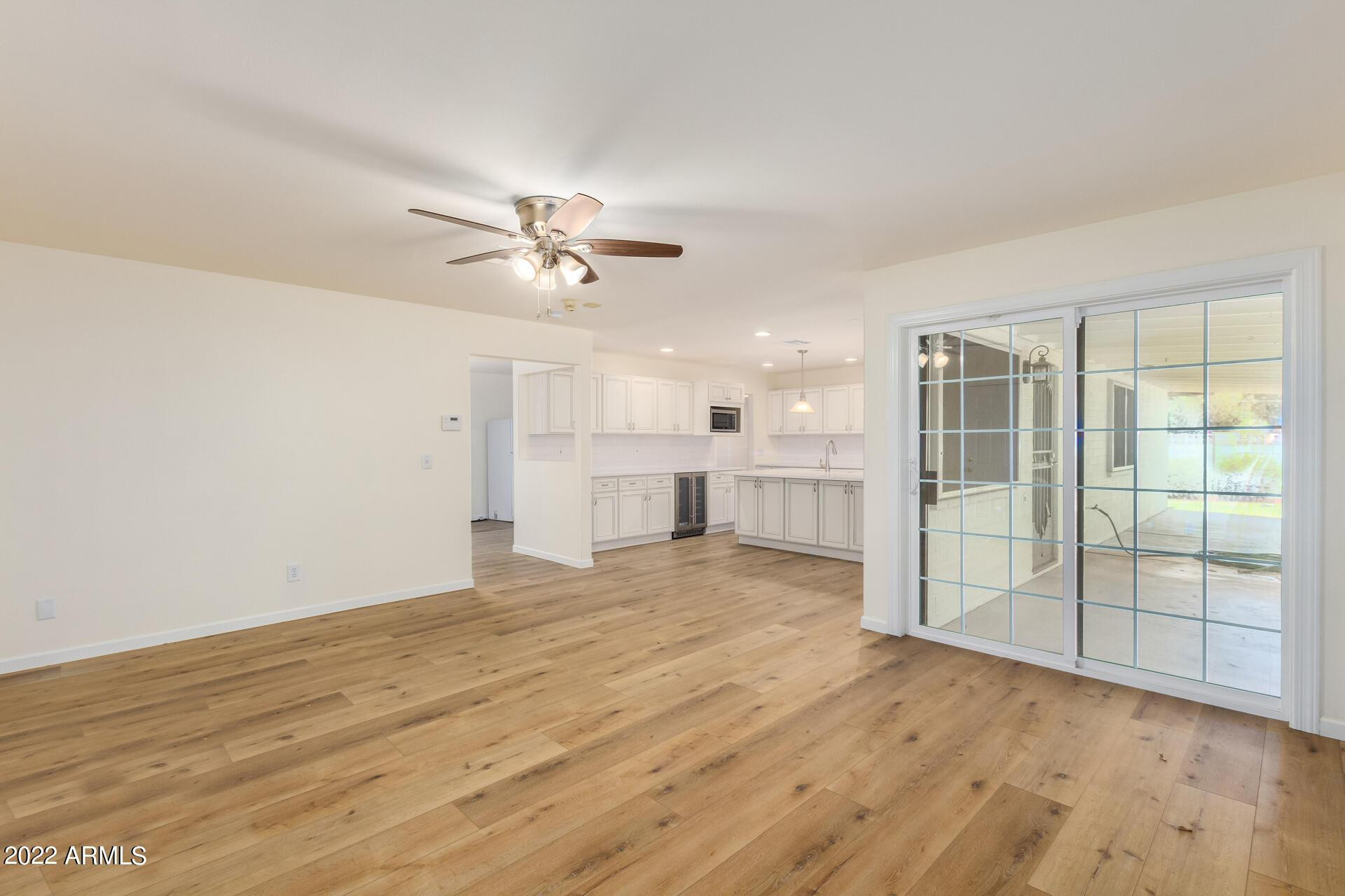 1211 West Hayward Avenue Phoenix, AZ 85021 - Photo 10 of 26 wooden floor in an empty room with a window
