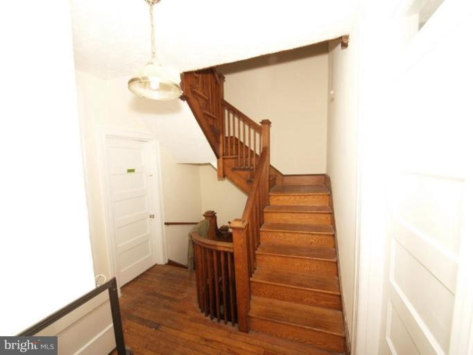 1121 Columbia Road Northwest Washington, DC 20009 - Photo 6 of 10 2nd floor stairs and original woodwork unpainted.