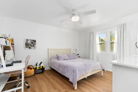 a bedroom with a bed and a window