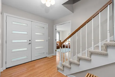 a view of entryway and hall with wooden floor