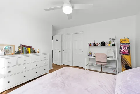 a bed room with a bed and a chair in it