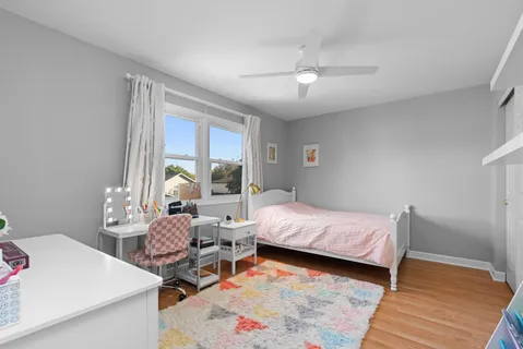 a room with a bed and wooden floor