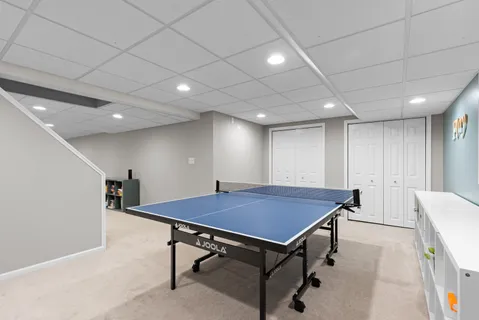 a room with furniture pool table and windows