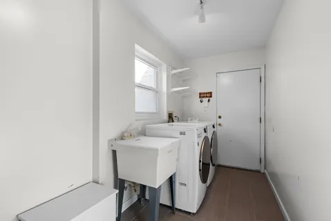 a view of a house with backyard and a tree