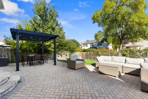 a view of a patio with table and chairs