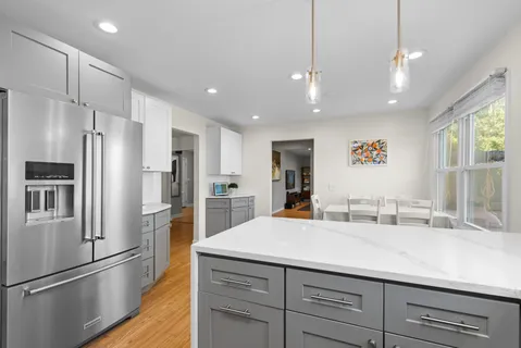 a kitchen with refrigerator and center island